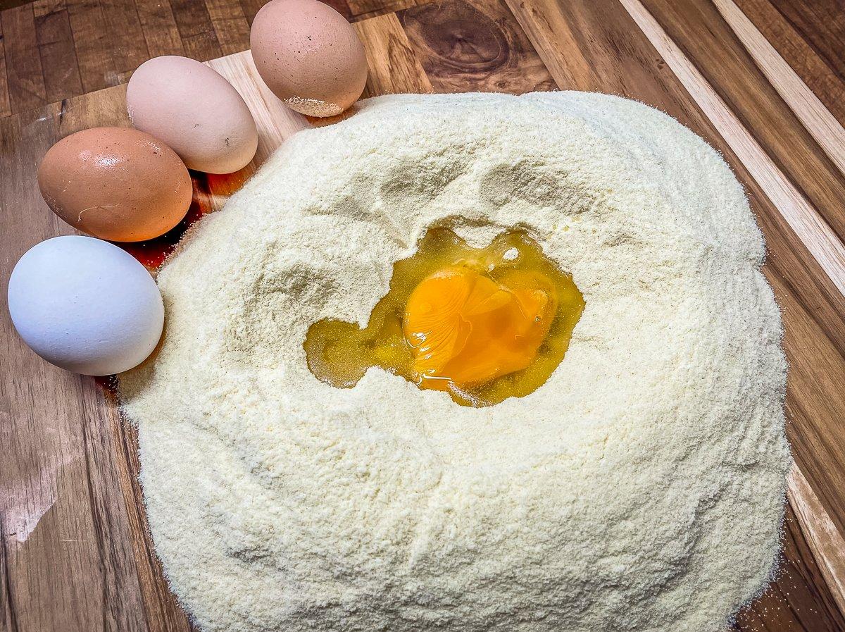 Make the pasta by blending the eggs into the flour.