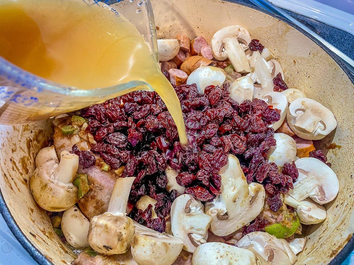 Add the dried cherries, apple cider, and mushrooms.