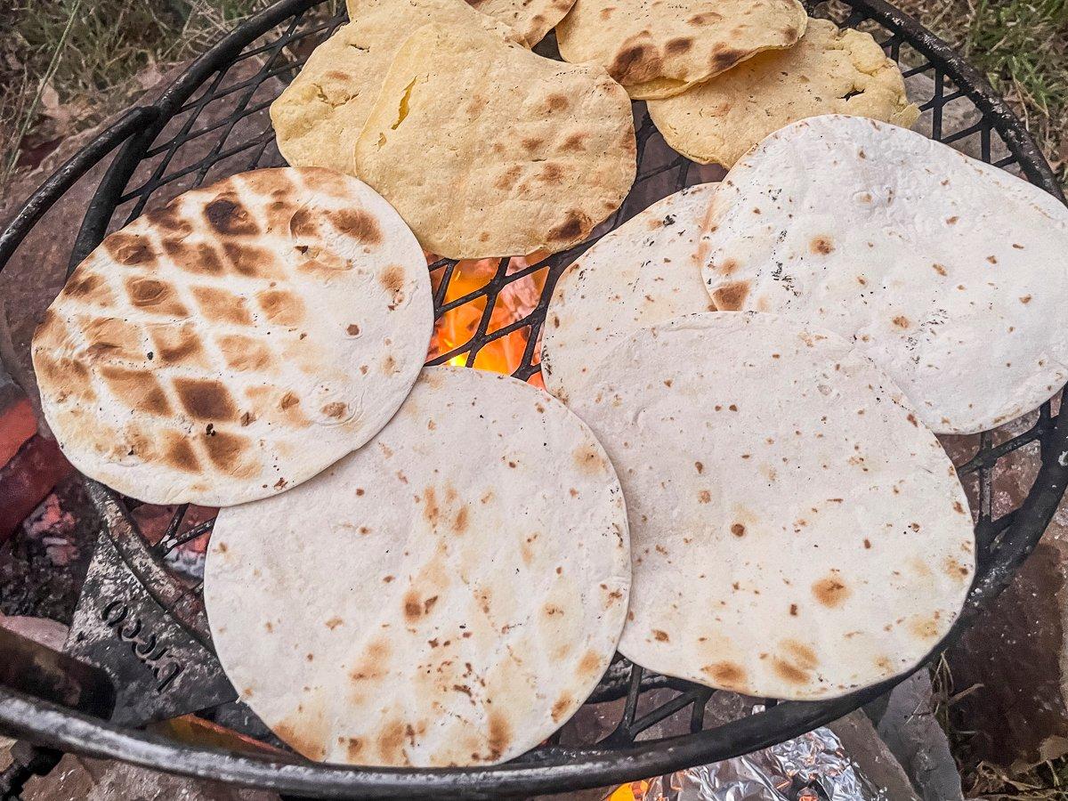 Toast the tortillas over the fire.