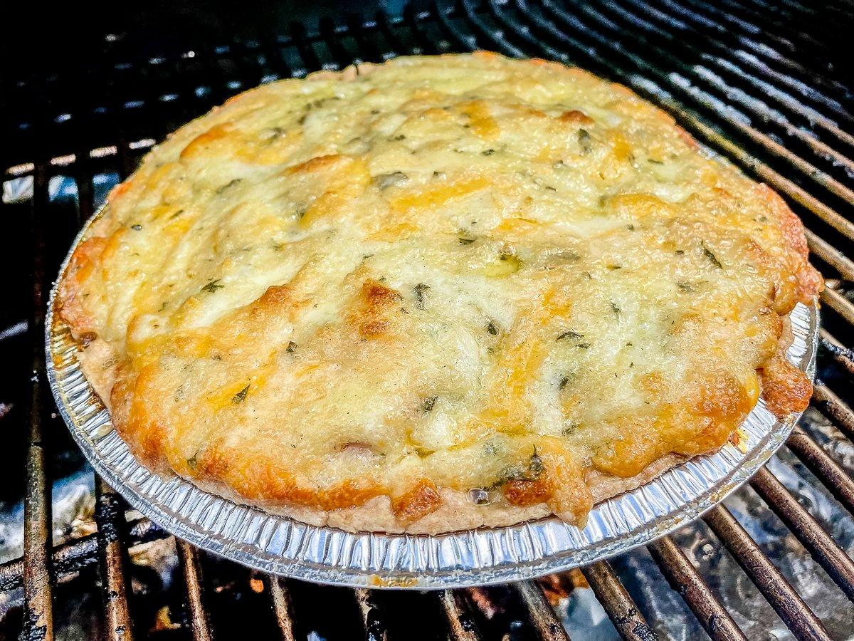 Grill the pie until the topping is golden brown.