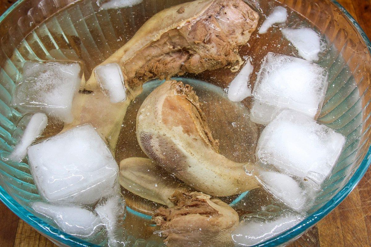 Submerge the tongues in cold water to stop the cooking process, then peel away the skin.