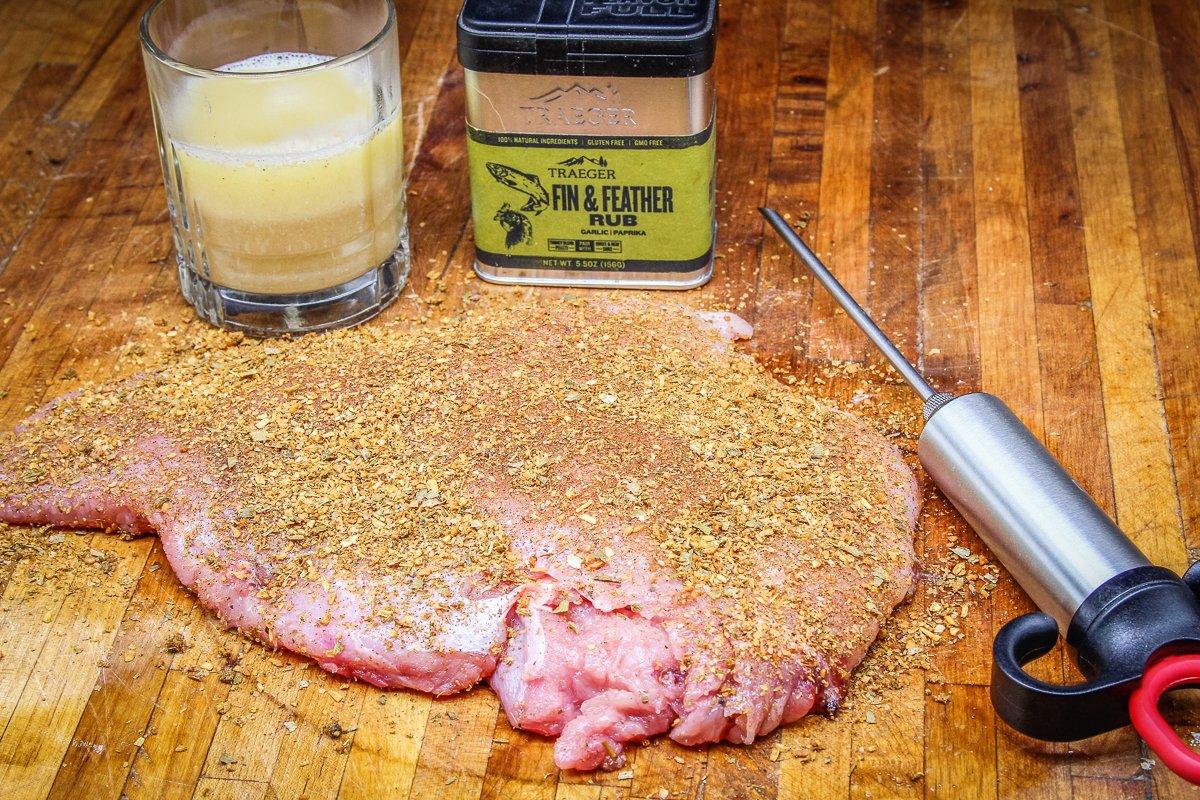 Sprinkle Traeger Fin & Feather Rub over the surface of the turkey breast.