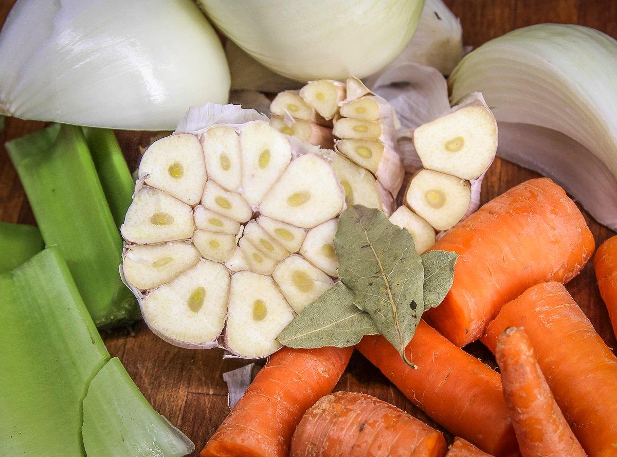 Add garlic, onion, carrots, celery, and bay leaves to the stock for extra flavor.