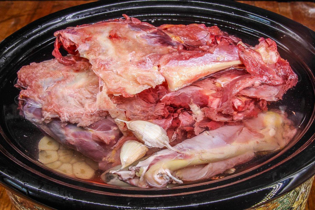 Add the vegetables, aromatics, and bones to the slow cooker, then fill to top with water.