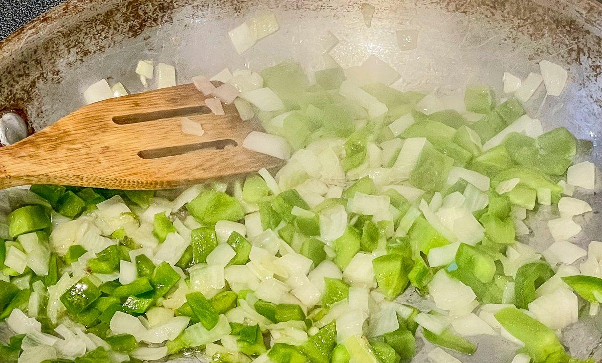 Sauté the onions and peppers until soft.