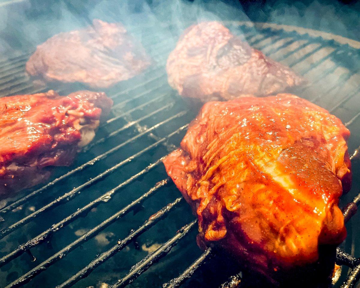 After smoking the thighs, move them to an aluminum pan and pour in a beer or some stock.