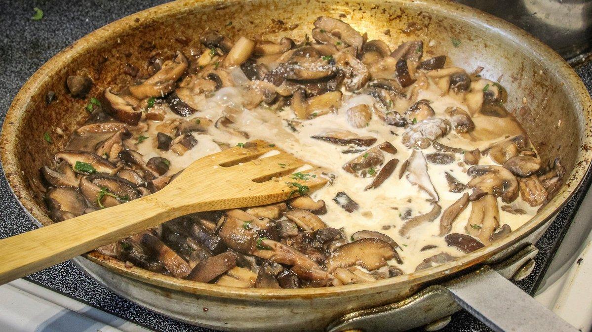 Add the wine and stock to the sautéed mushrooms, reduce the liquid to intensify flavor, then stir in the stock.