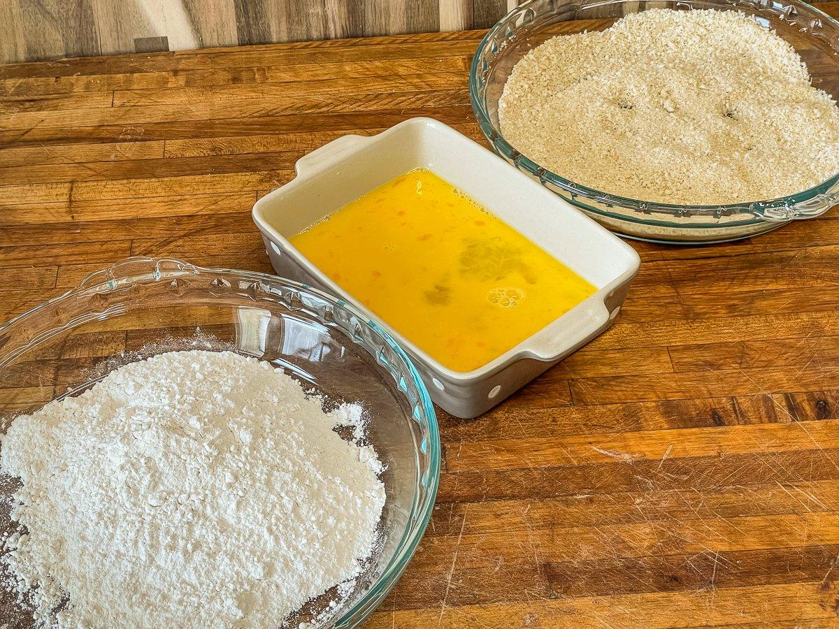 Set up a three stage dipping station of flour, beaten egg and seasoned bread crumbs.