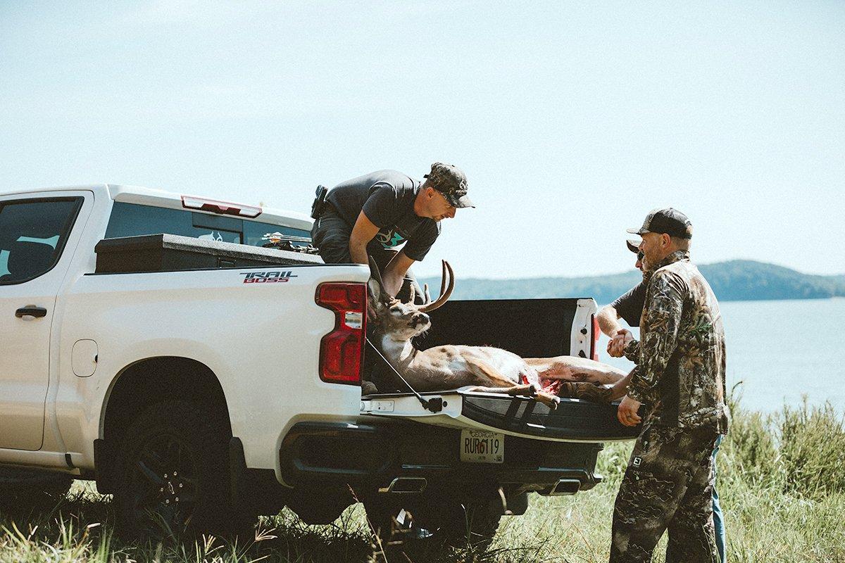 Killing a deer during warm weather means getting it loaded and to a walk-in cooler or quartered up and on ice quickly. Having a few buddies around speeds the process. Image by Kerry Wix