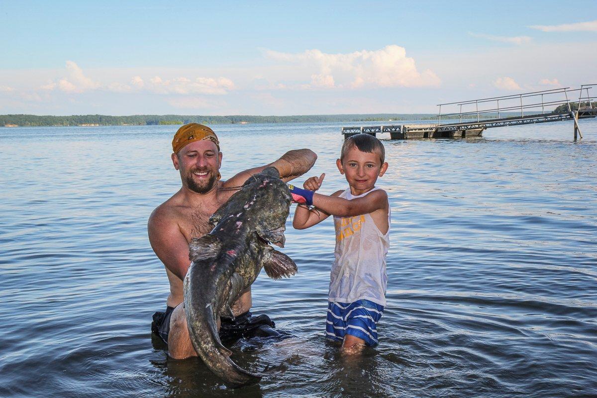 Showing off an average-sized flathead caught by noodling. 