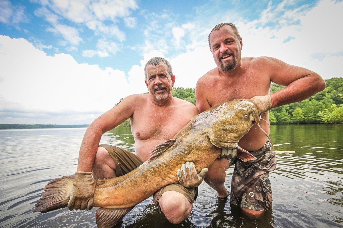 Fred and Tim (right) show off one of our biggest flatheads to date. Like most of the fish we catch, this one was released.
