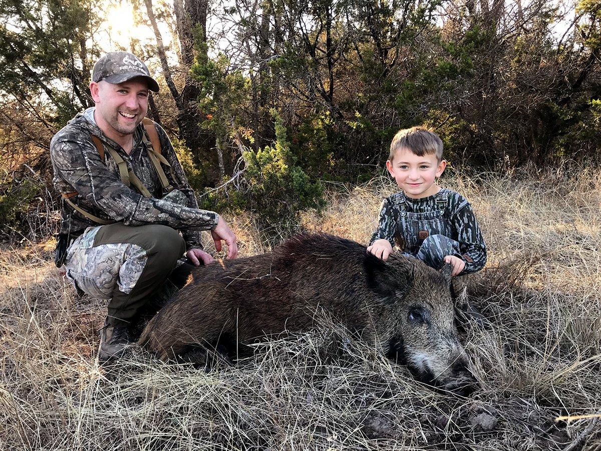 The author and his son with a Texas pig.