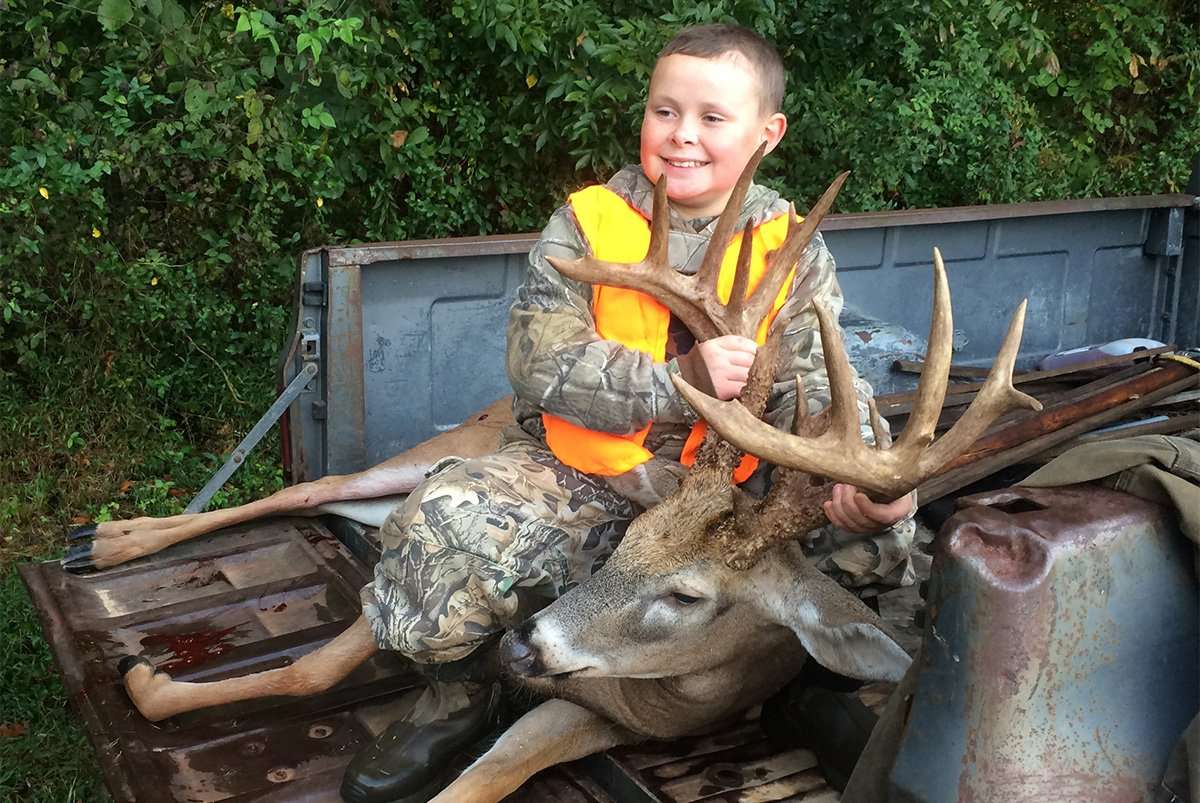 Mason Bennett proudly shows off his buck in the back of a Chevy truck. (Bennett photo)