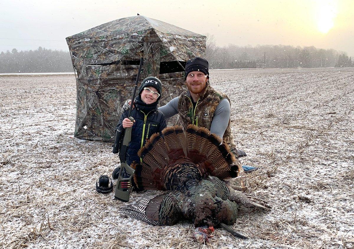 Levi Brandt, 8 years old, found success when the author called this Wisconsin tom in off the roost from 650 yards away. The lone tom gobbled and strutted the entire way through sideways-blowing snow. Image by Darron McDougal