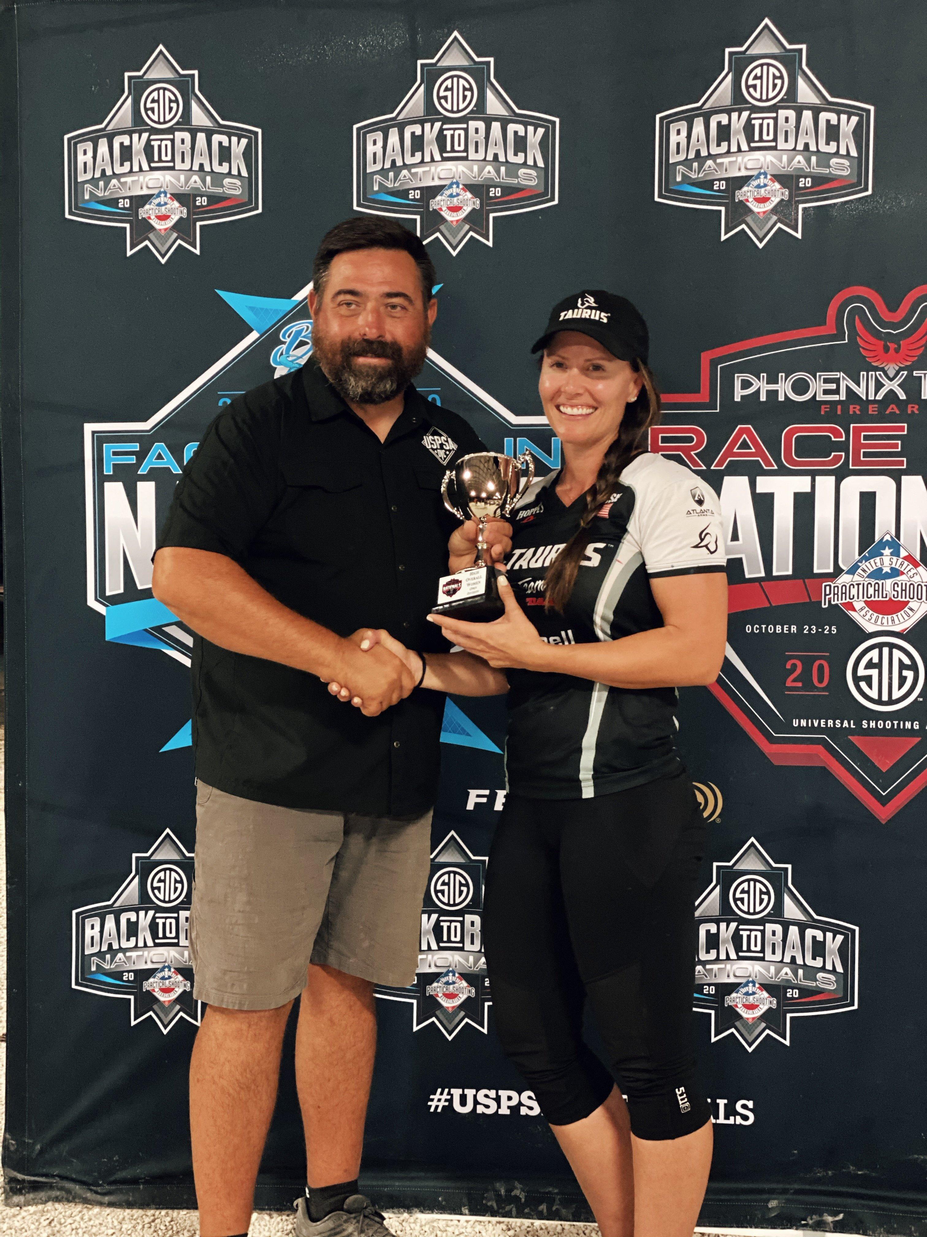 President of USPSA, Mike Foley, congratulates Jessie Harrison for her win at the 2020 Race Gun Nationals.