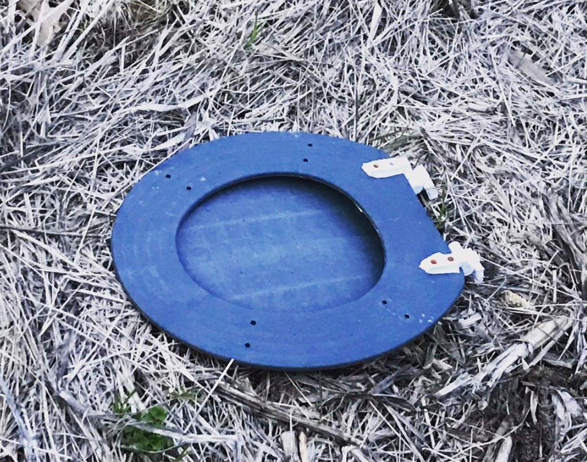 This toilet seat was found in the middle of a corn field. (Image provided by Josh Honeycutt)