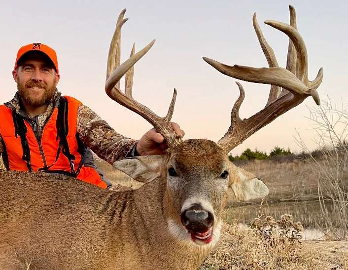 Kyle Barefield happily displays his big Oklahoma whitetail. Image by All Things Hunting