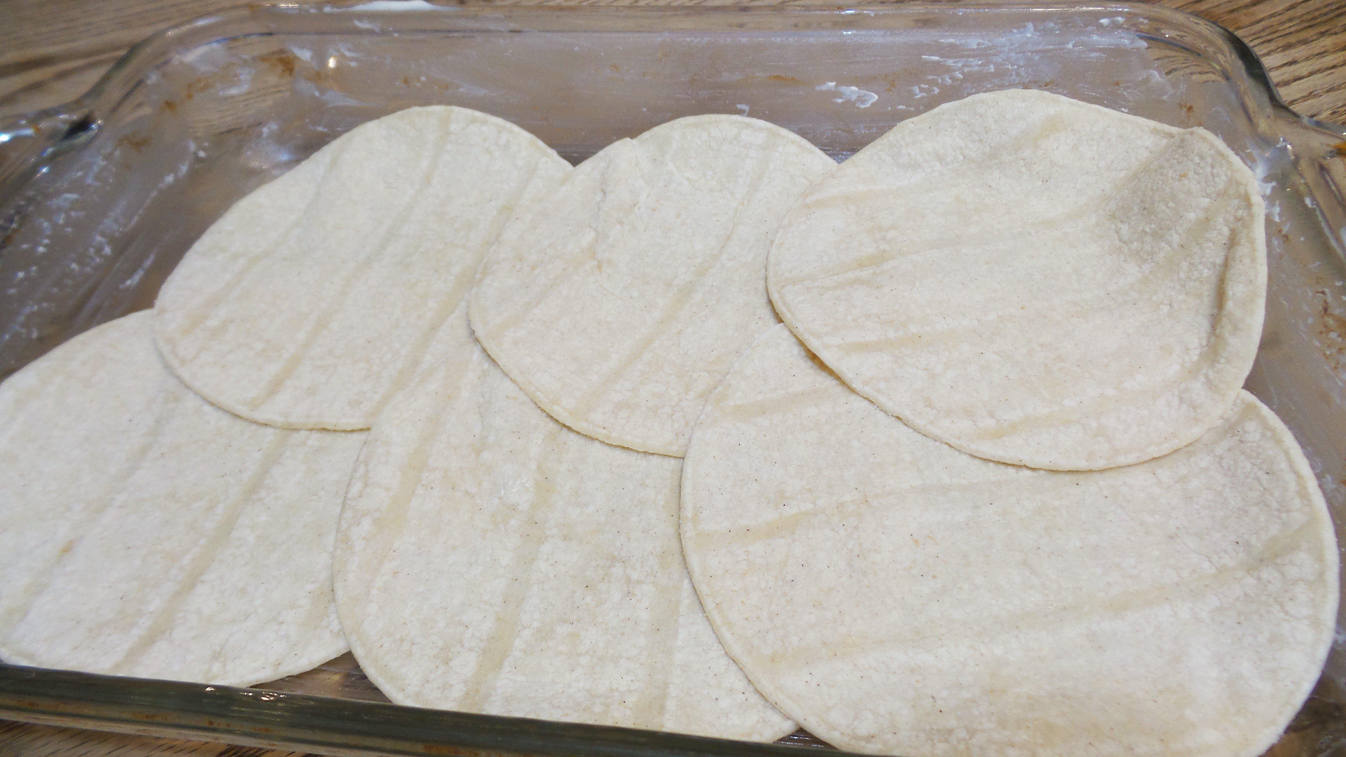 Line the dish with tortillas.
