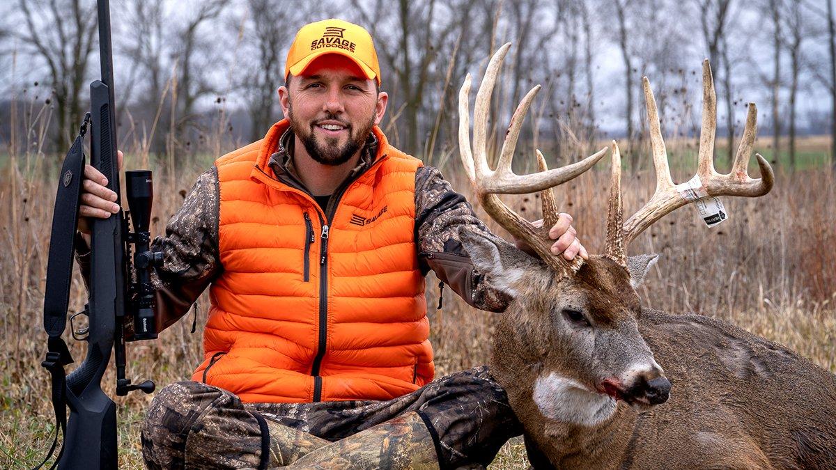 Mike Stroff, who is an outfitter and guide, sits beside a big buck of his own. Image by Mike Stroff