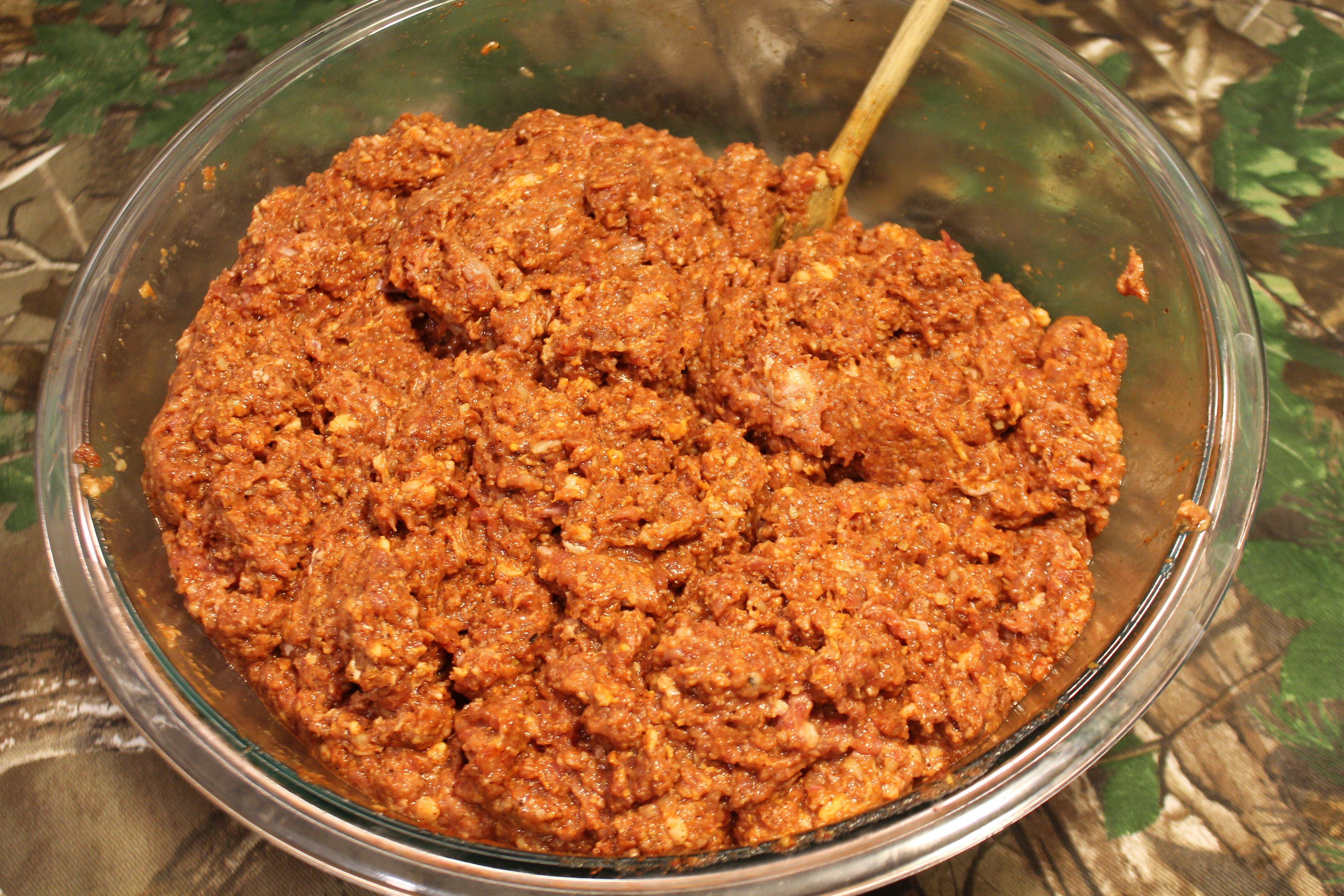 Mix the garlic, liquids and spices into the pork.