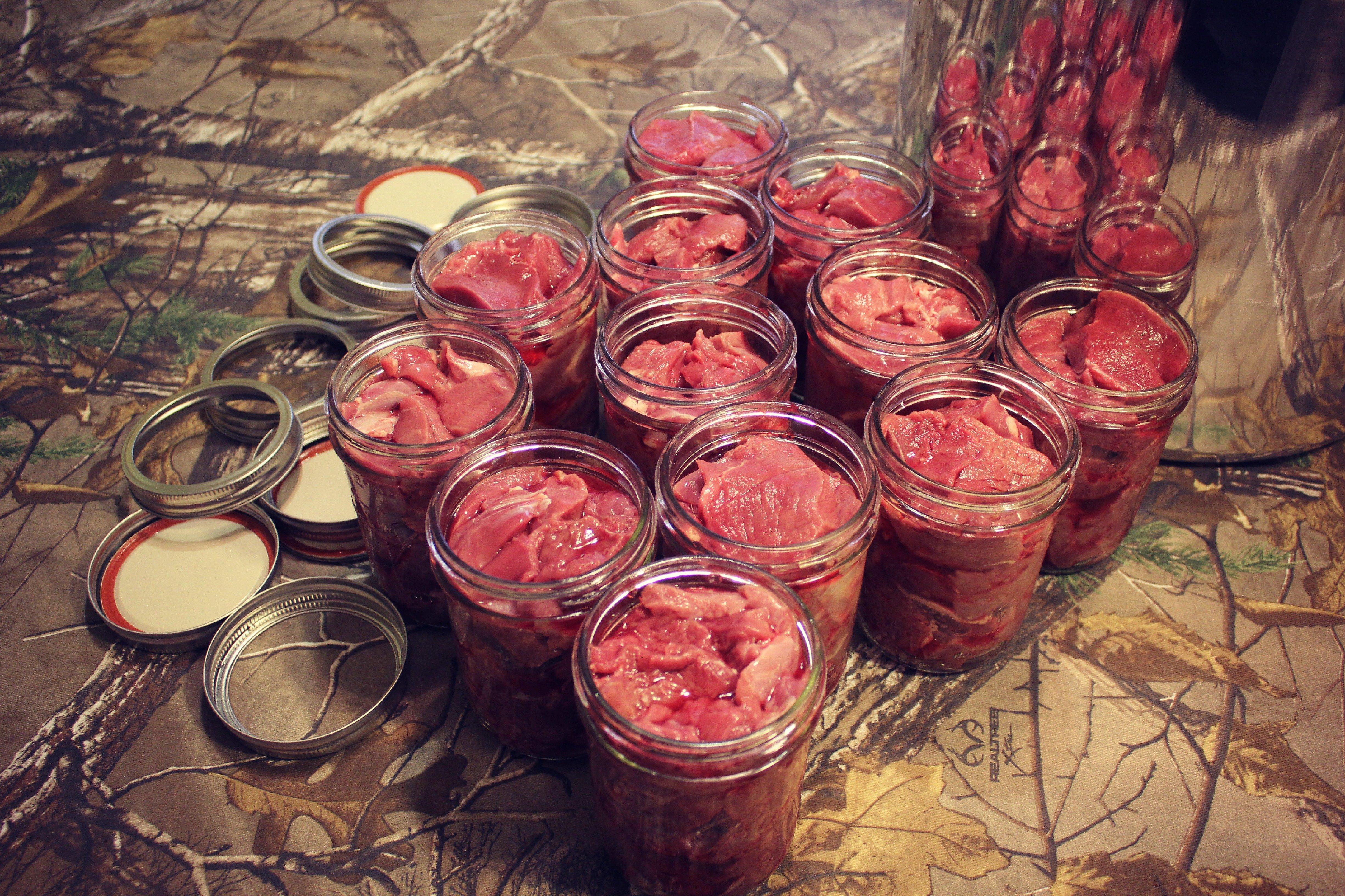 Pack jars tightly with trimmed venison, making sure to remove any air pockets.
