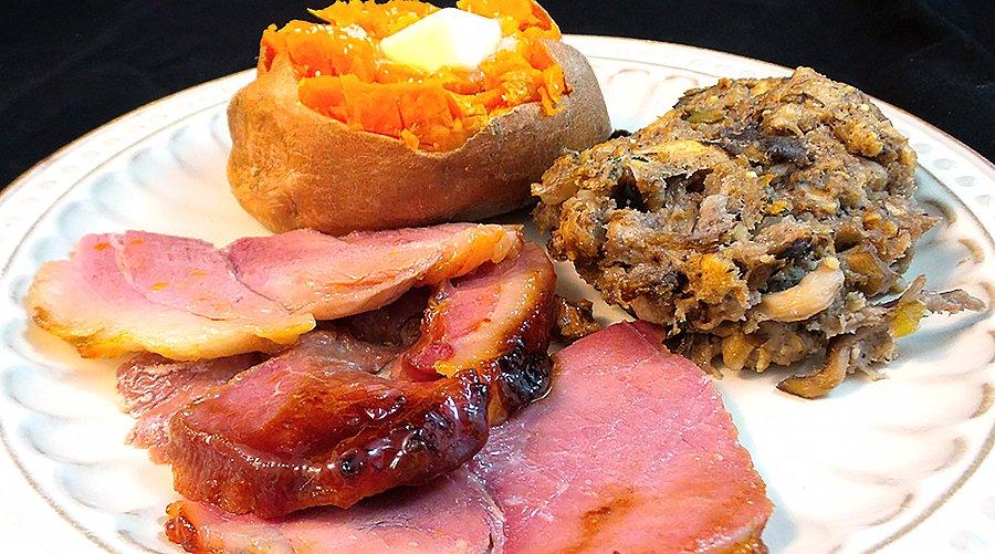 A wild plate including wild pork ham, wild mushroom and walnut dressing and a home grown sweet potato.