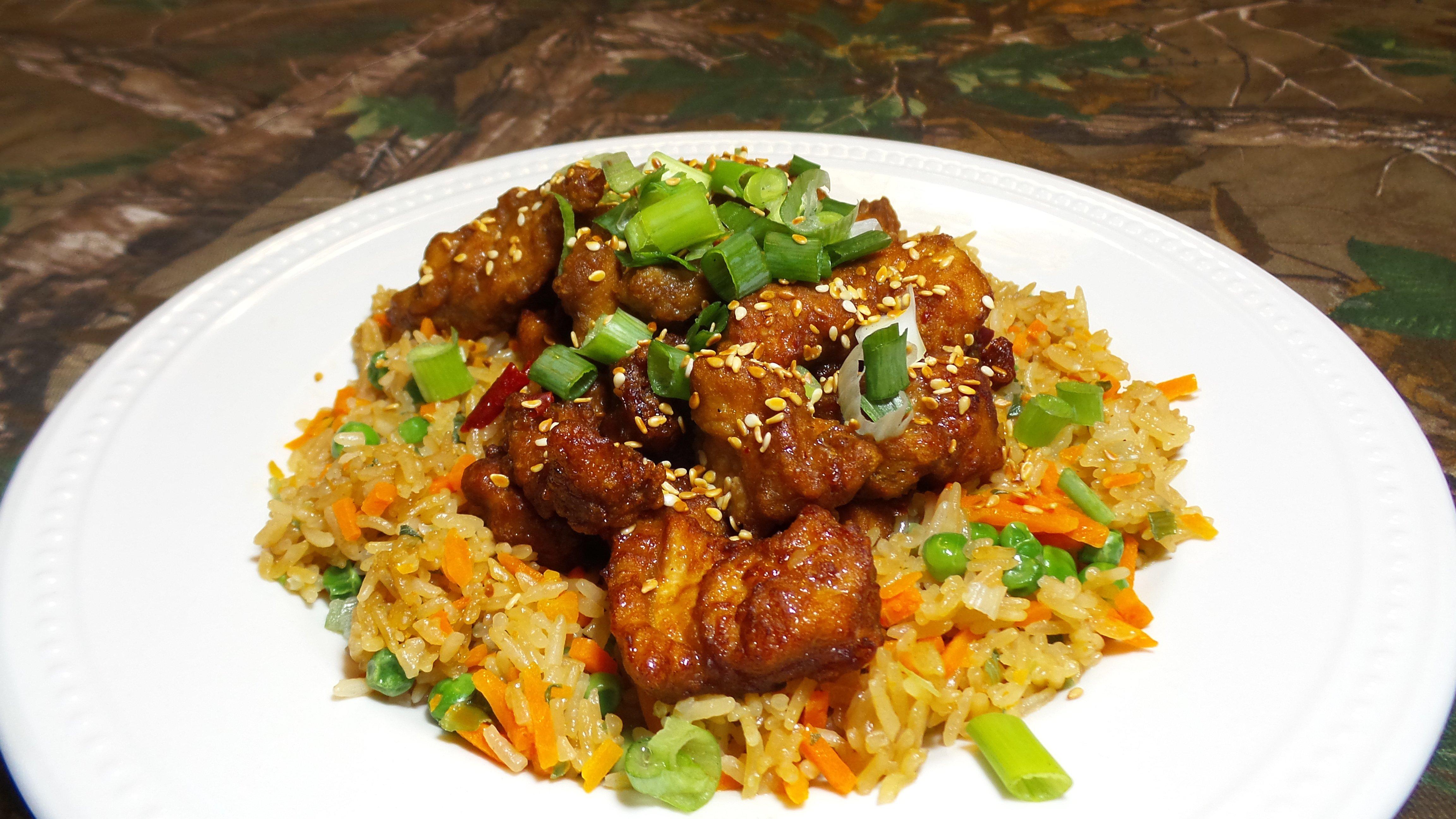 Serve over fried rice and top with chopped green onions and toasted sesame seeds.