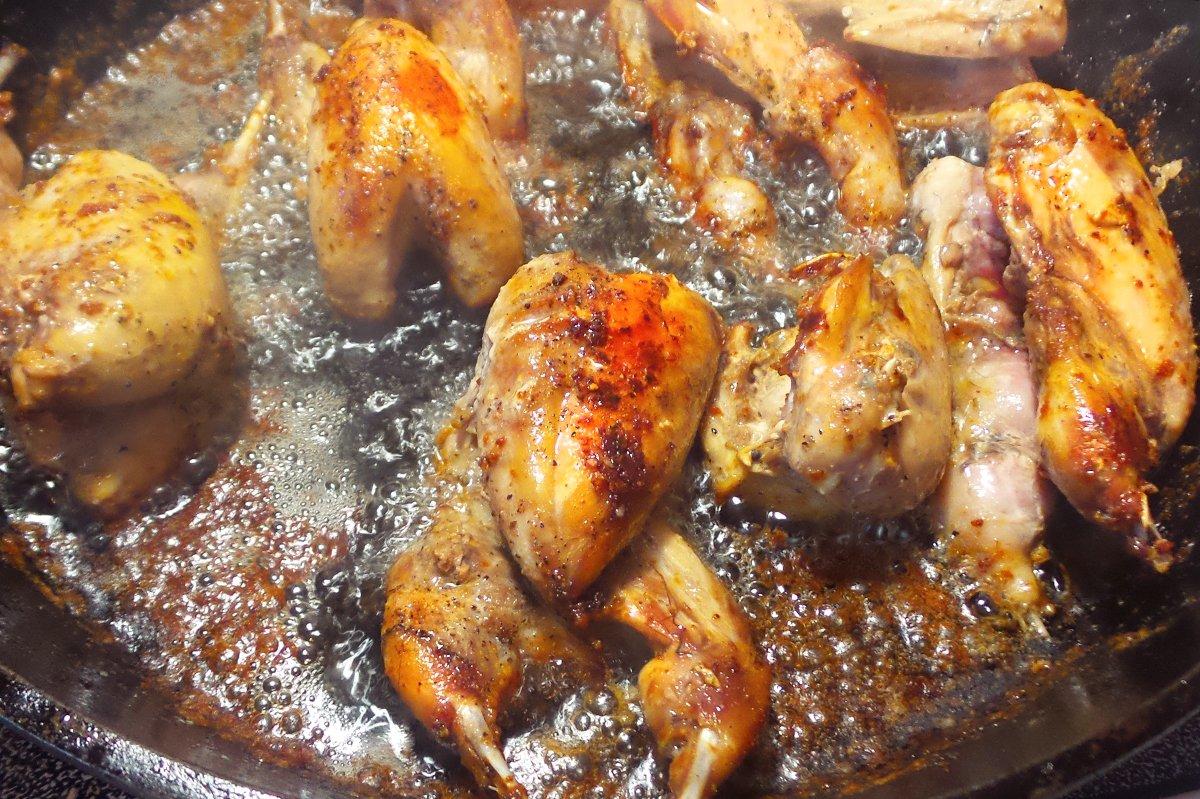 Brown the seasoned quail in butter and vegetable oil.