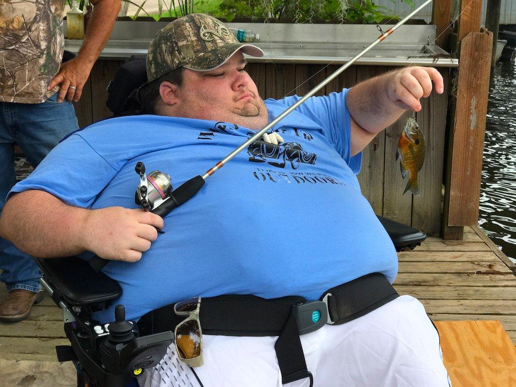 Billy Daw of Wheelchair Outdoors unhooks a fish. (Billy Daw photo)