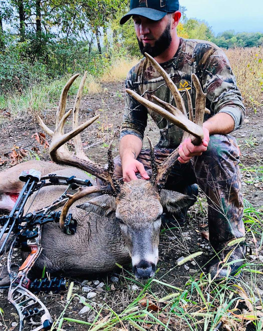 Creston Wolford admires the giant non-typical buck he arrowed in Missouri between thunderstorms. (Photo courtesy of Creston Wolford)