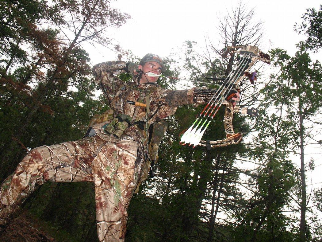 Downhill shots are quite common in a wide variety of bowhunting situations. Maintaining consistent T-form between bow and drawing arm is important, whether that means bending at the waist, or bending a knee to adjust to topography falls. (Patrick Meitin photo)