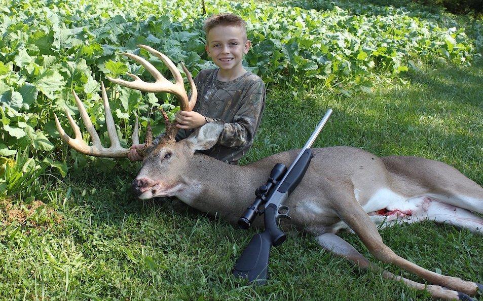 Ezra poses with his huge buck. (Photo courtesy of Dave Oettel)