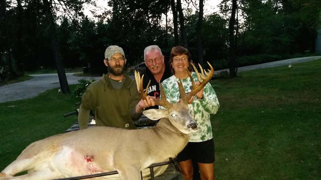 The landowners were eager to jump in next to bowhunter Matt Ornes and his buck for a quick photo. (Photo courtesy of Matt Ornes)