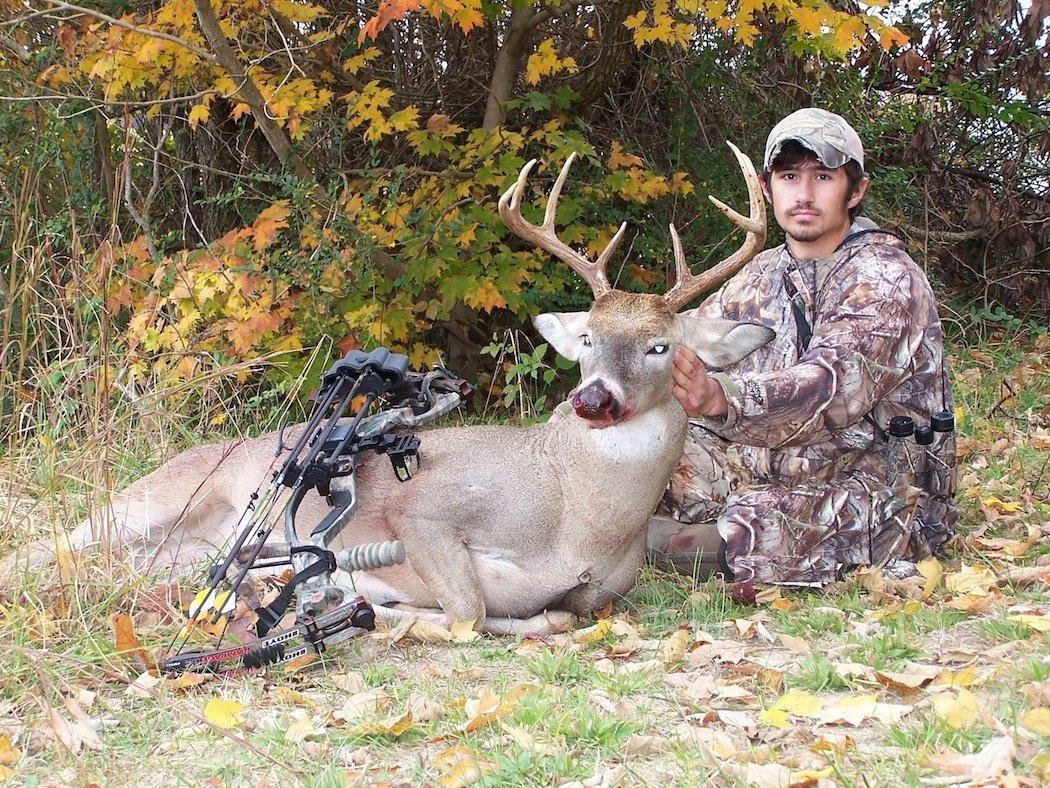 The author poses with a big-bodied buck he shot in 2012 during a cold front just days before Halloween.
