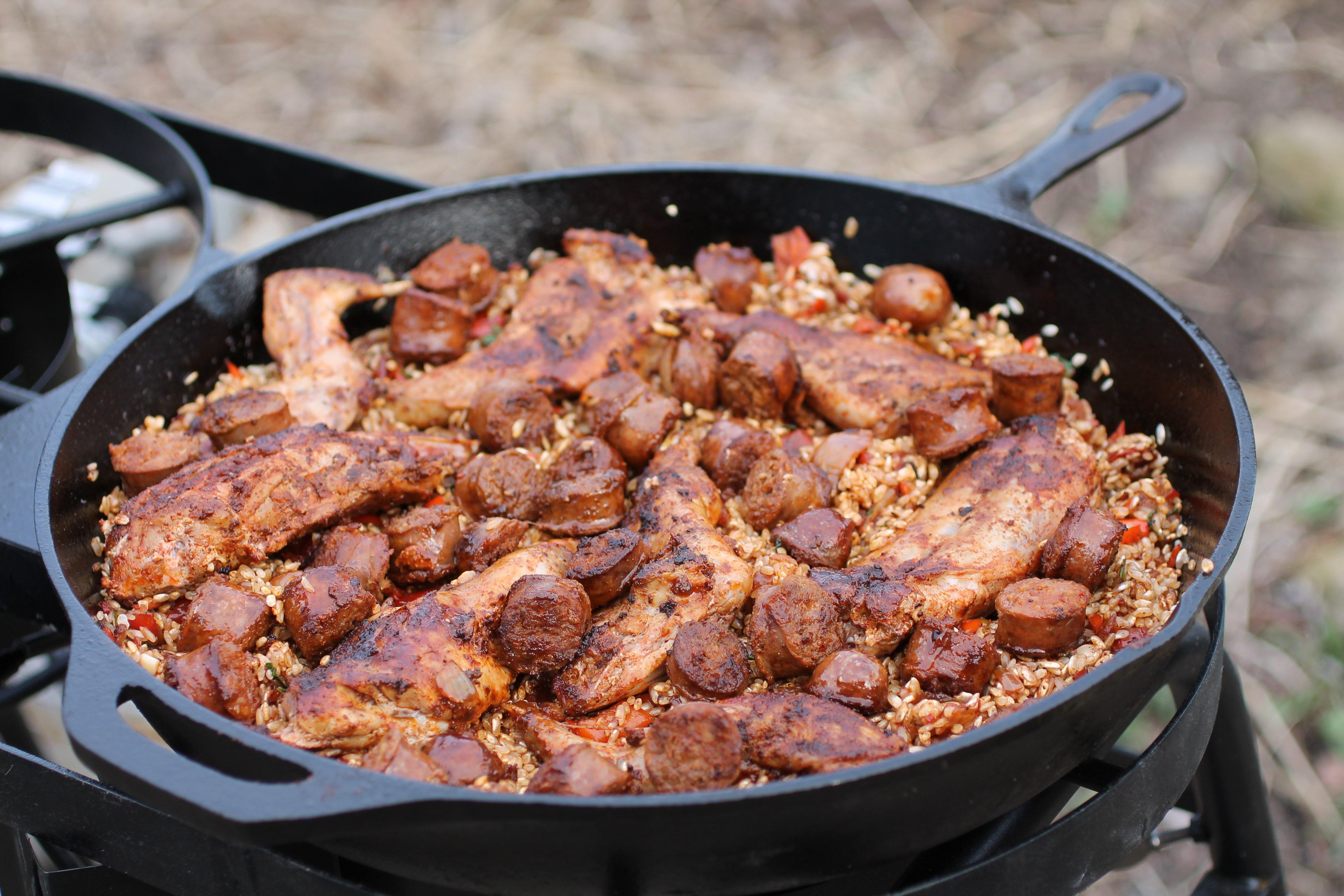 Return the meat to the pan of rice and vegetables.