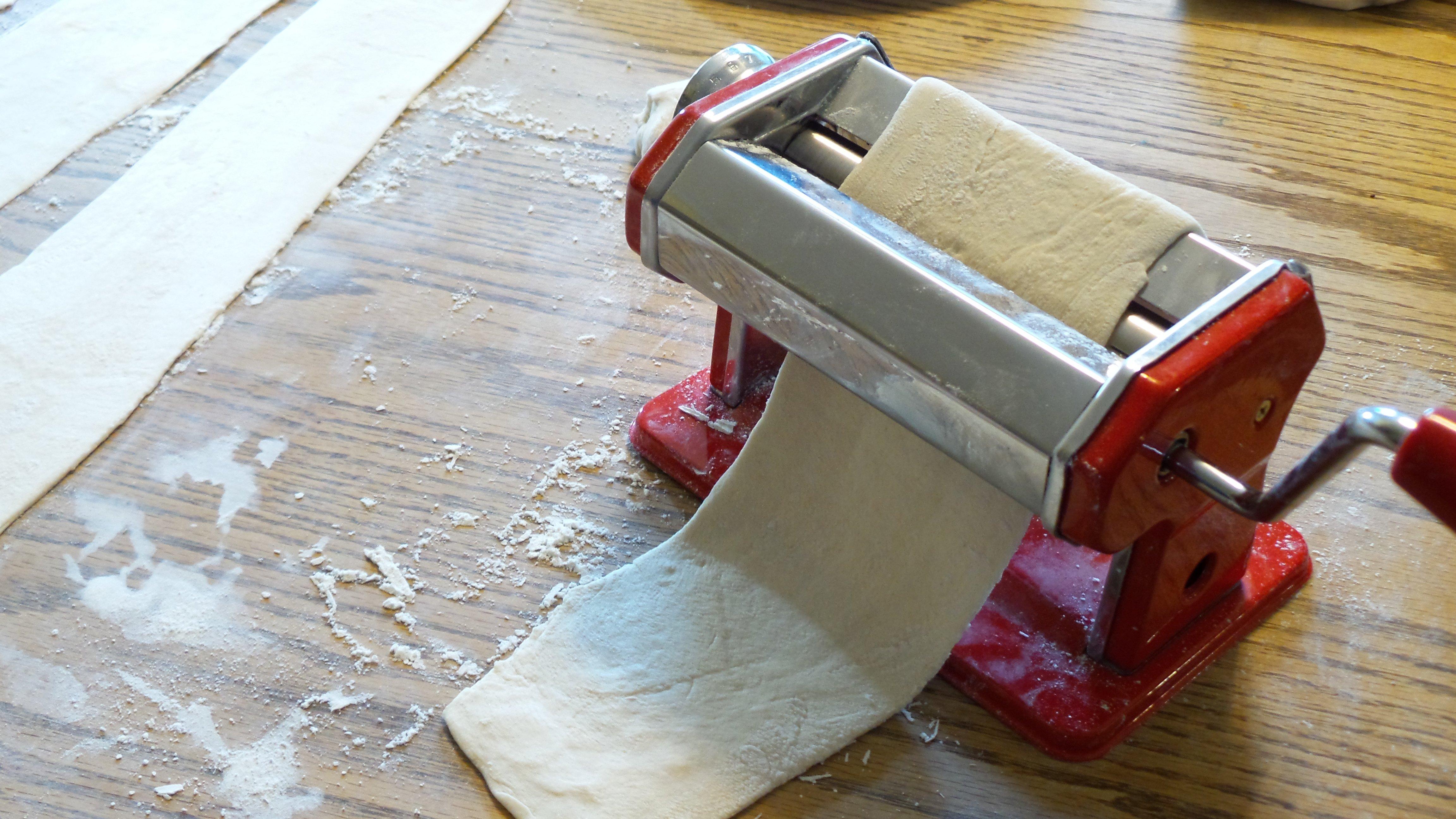Roll out a thin layer of dough through the pasta machine.