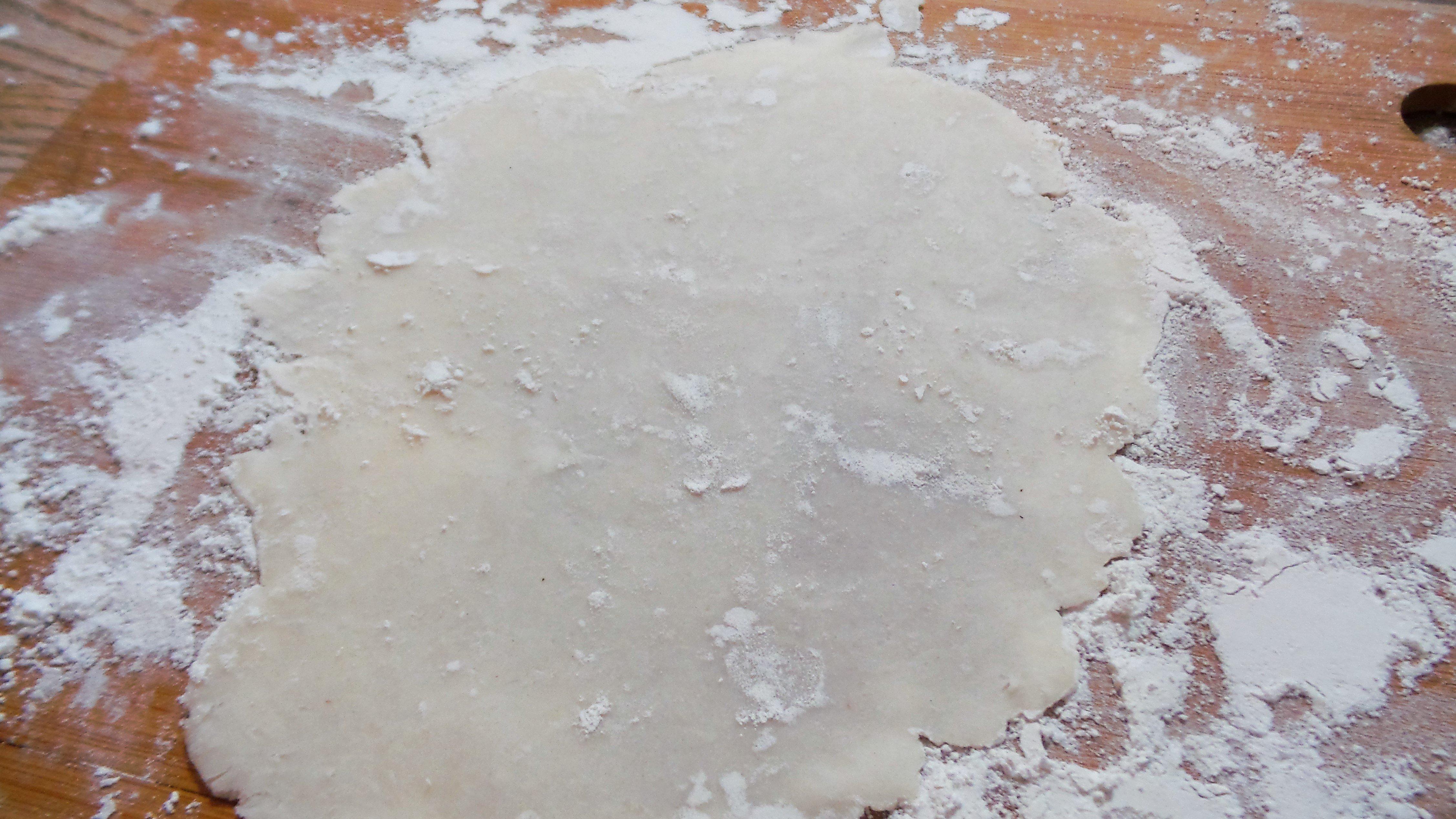 Roll the dough into thin rounds.