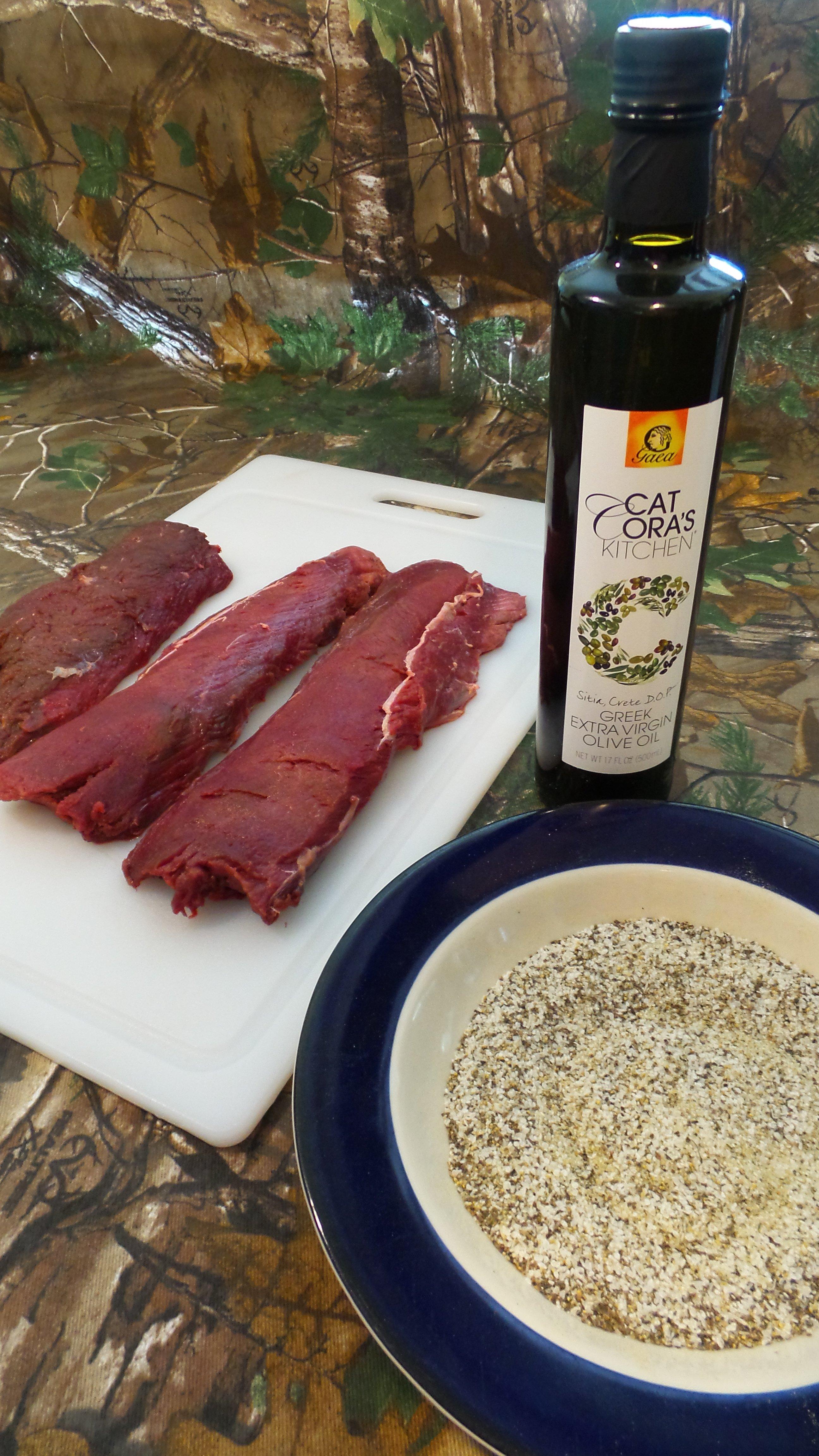 Rub the backstraps with olive oil and season with house blend seasoning.