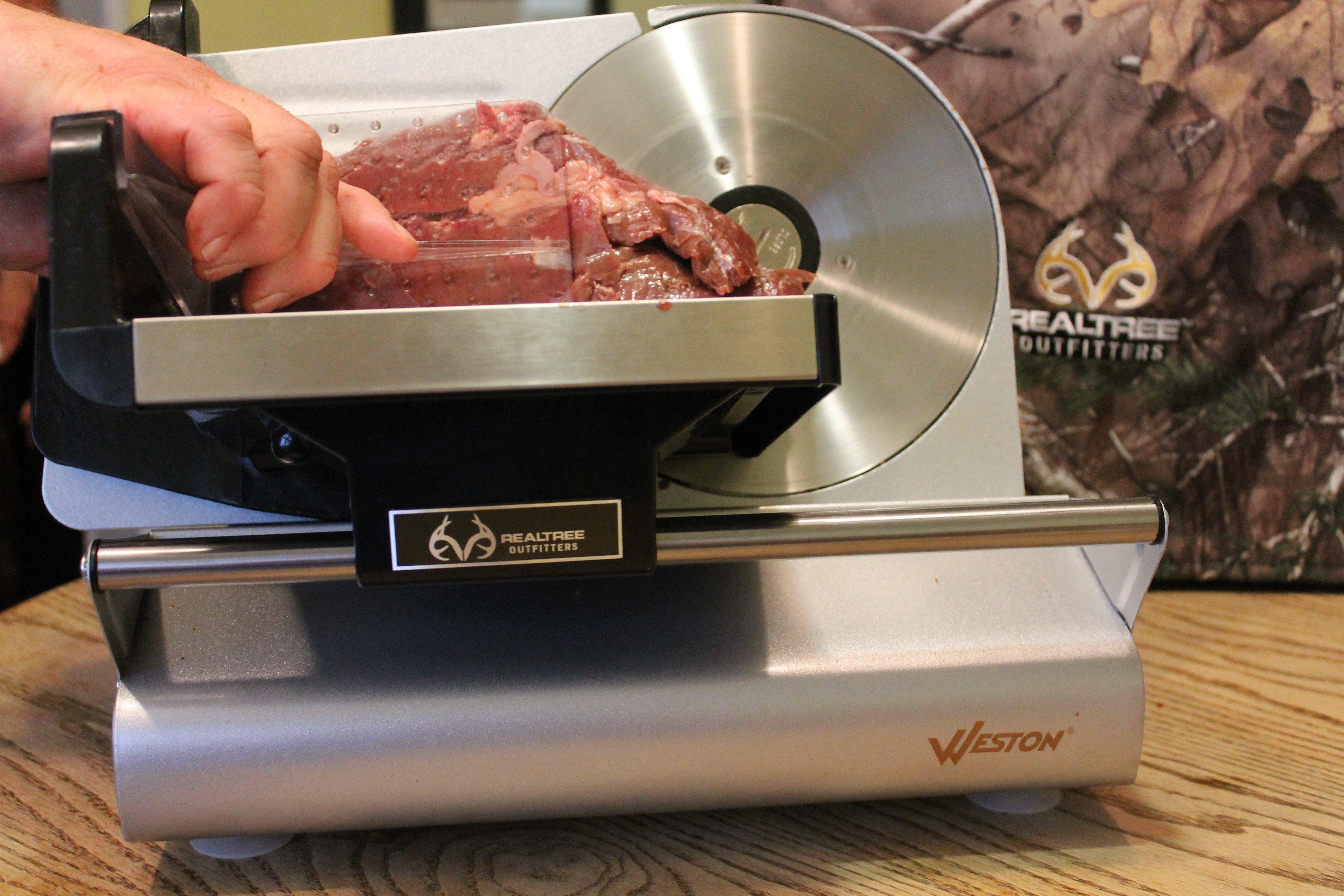 Slicing a roast on a rotary slicer.