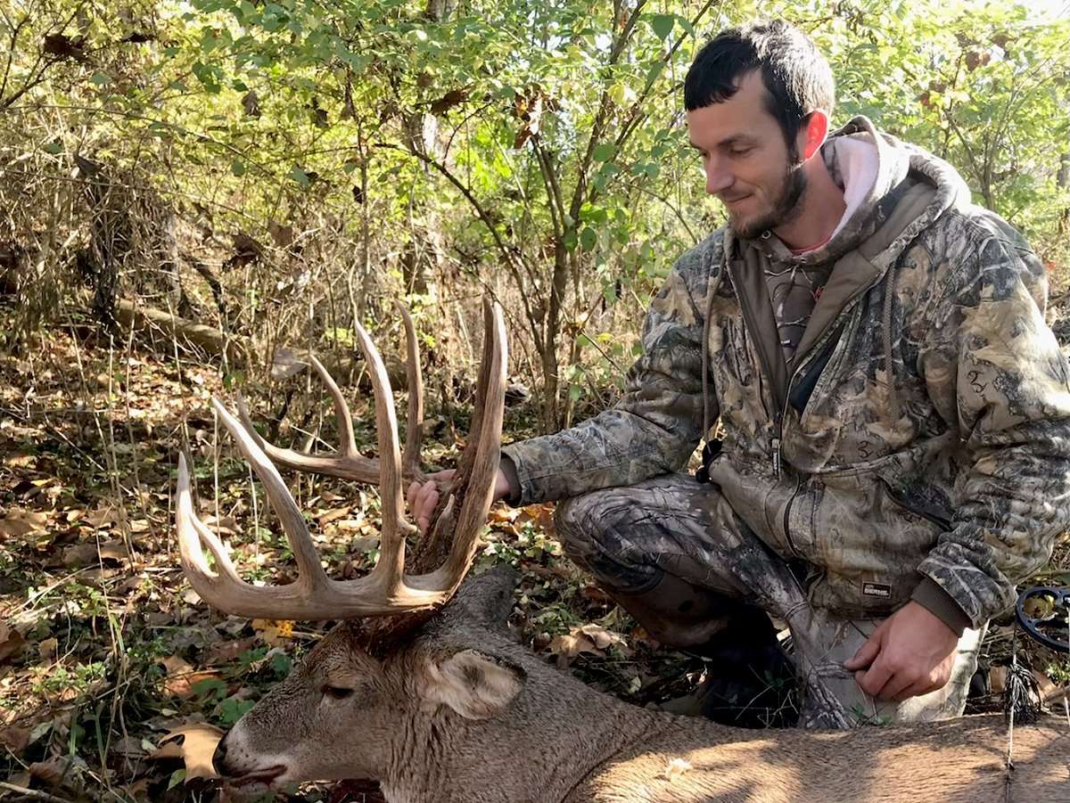 Stoll admires the mid-190-class buck he arrowed late in the morning Nov. 3. It was more than 60 inches larger than his previous best buck. Image courtesy of Emanuel Stoll
