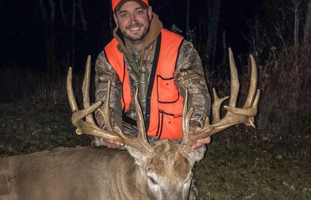 Travis Mlodik happily shows off his huge Wisconsin rifle buck. (Travis Mlodik photo)