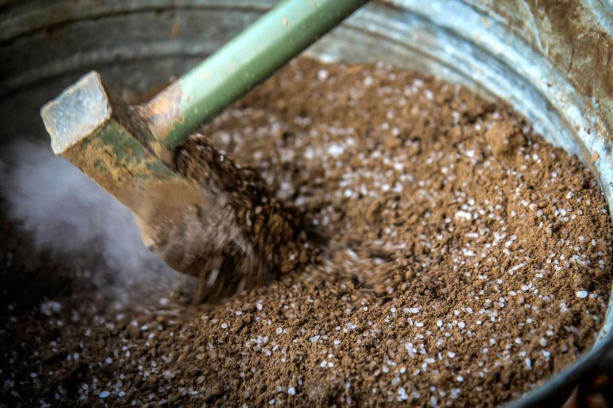 Blend fine, sifted dirt with flaked wax over heat to make waxed dirt. 