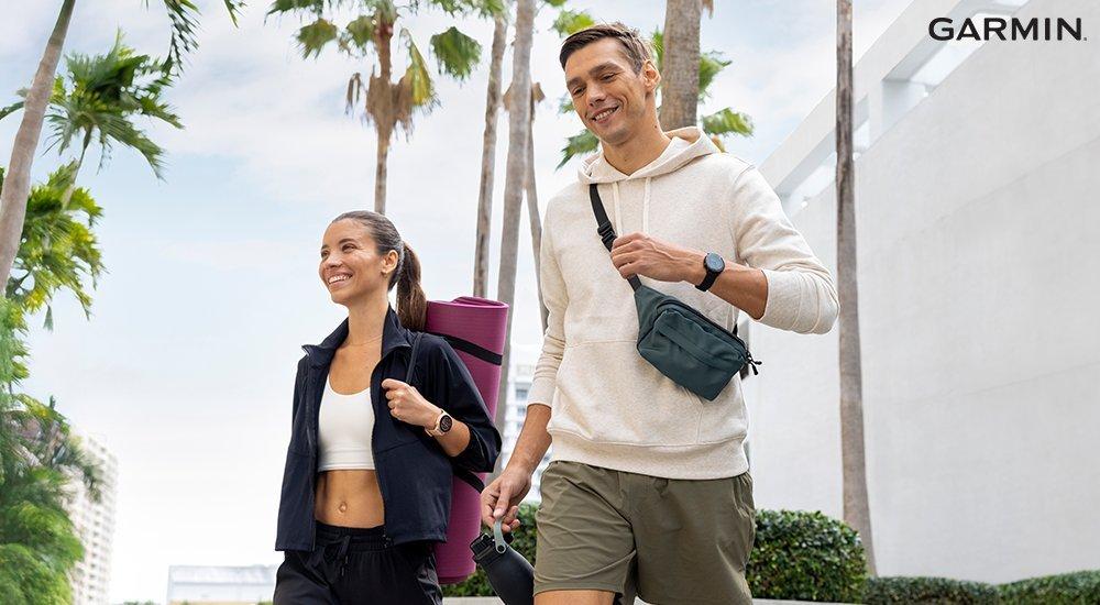 a couple walking out of a fitness class with their garmin watches