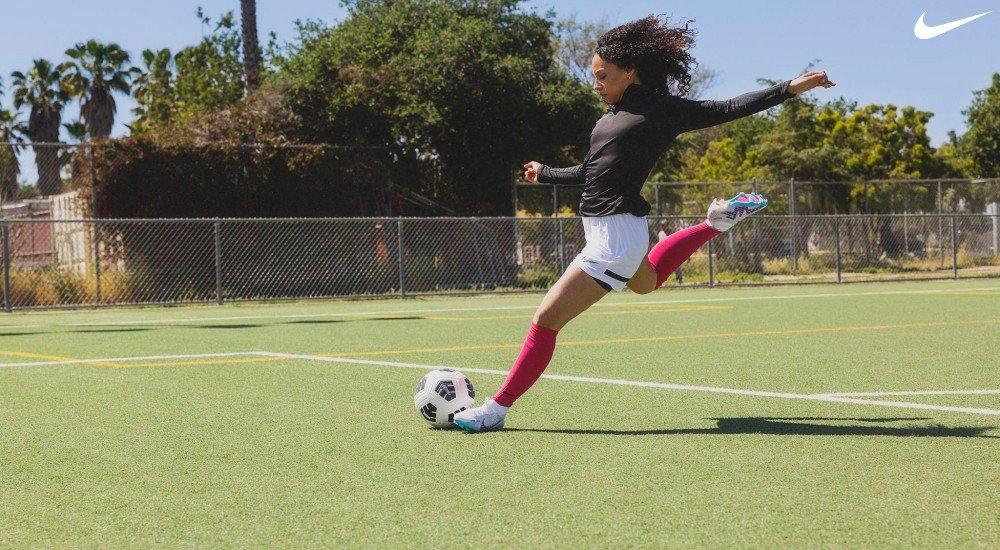 a female playing soccer in Nike soccer cleats