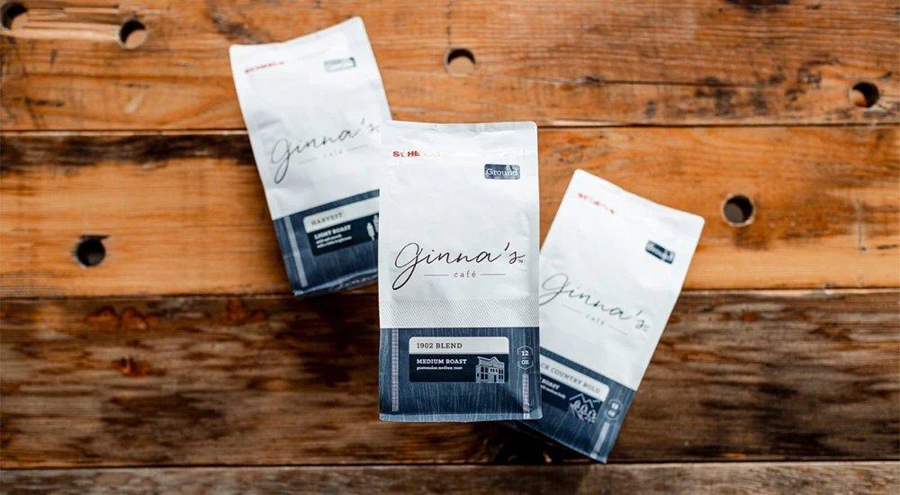 three bags of ginna's coffee beans on a table