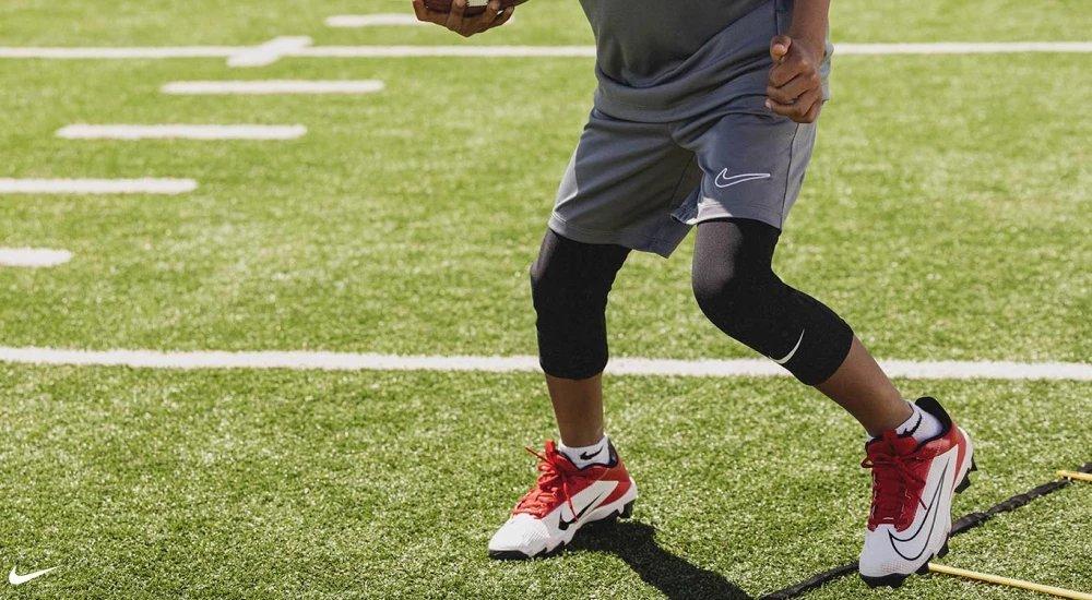 a player wearing a pair of Nike football cleats at practice