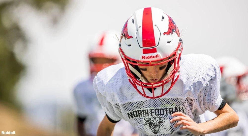 a boy wearing a football helmet when in practice