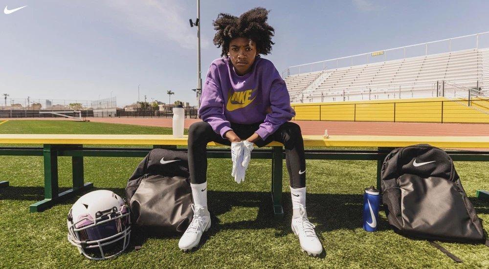 a player sitting on the bench with all his football gear