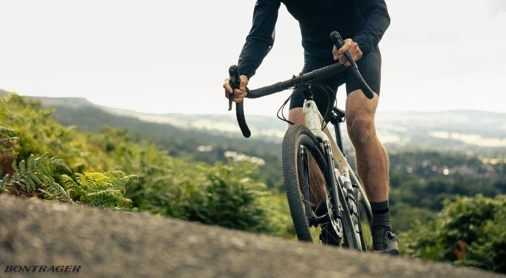 a person mountain biking on a trail