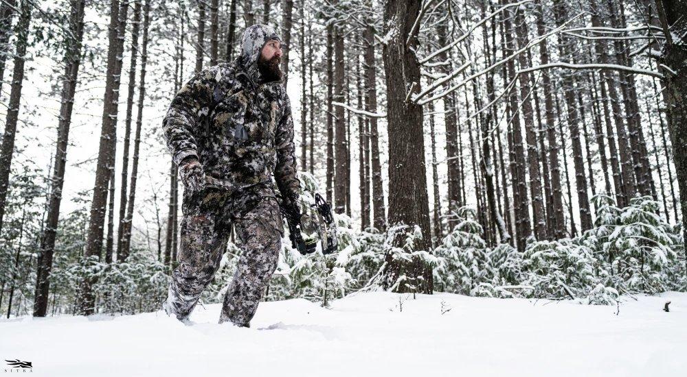 a man wearing SITKA hunting gear in the snow